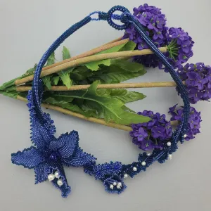 Luxury handmade jewelry with blue beads and floral design.